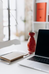 a laptop and notebook showing blogging 