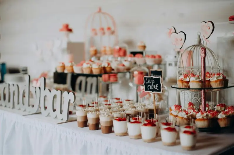 dessert table with chalkboard cupcake label card and tiered display for home gathering