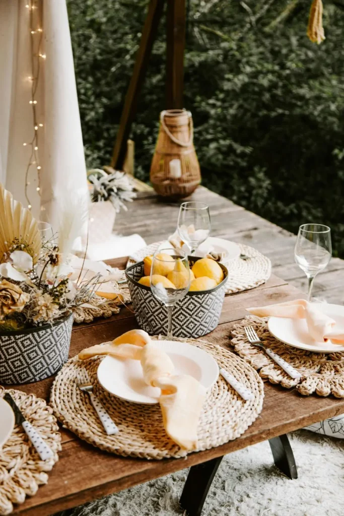 rustic boho table setup with woven placemats wooden table and pampas grass centerpiece ideas