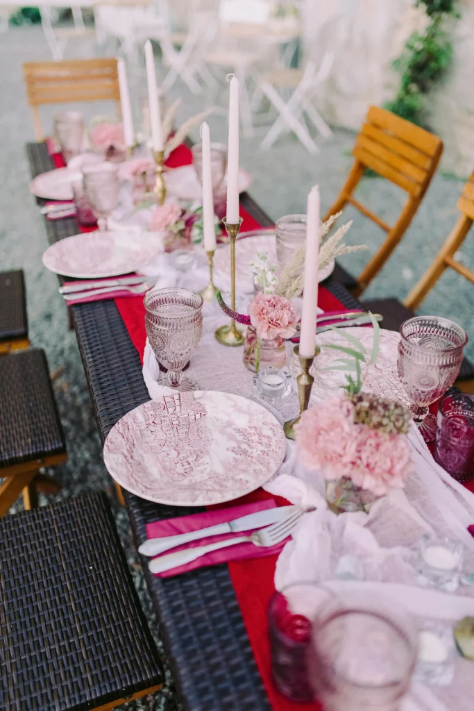 The Blush and Pink Romantic Table
blush and pink romantic table setup with gold taper candles cheesecloth runner and pink carnation flowers