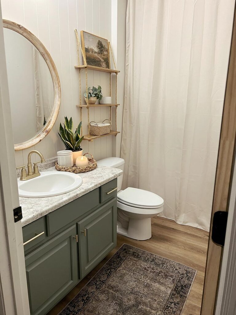Hanging rope shelves above toilet in small bathroom with framed print on top shelf, small plant and woven basket