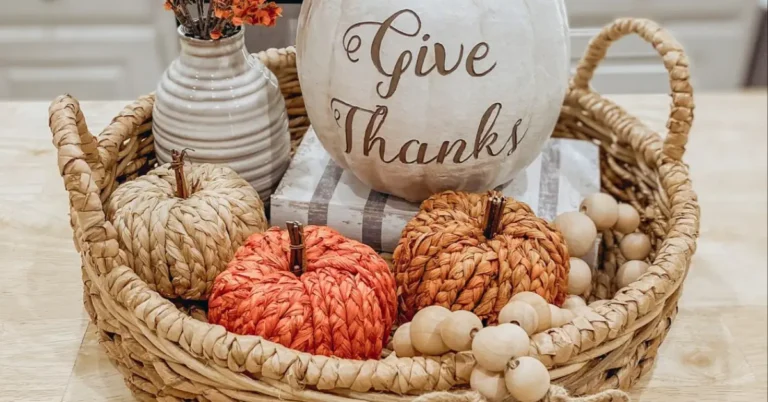 Fall centerpiece ideas with woven pumpkins, a dried flower vase, and a Give Thanks pumpkin in a wicker basket