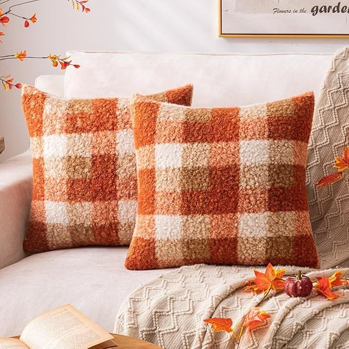 Fall leaf print pillow covers styled on a couch in a small apartment living room