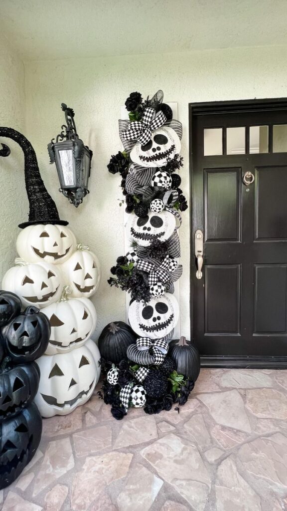 Black and white skull-faced pumpkin wreath decoration on a front door