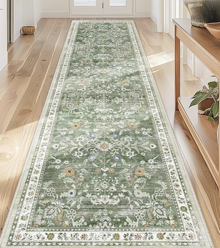 Sage green floral runner rug in a kitchen entryway on wood flooring