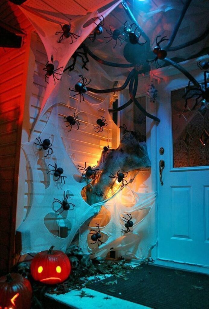 Lit "Trick or Treat" marquee sign with a candy bowl on a porch