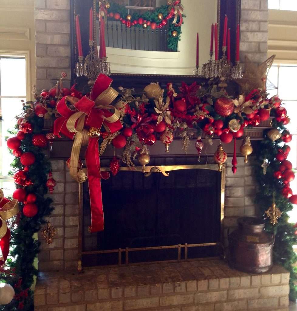 Christmas mantel garland with an oversized red and gold statement bow