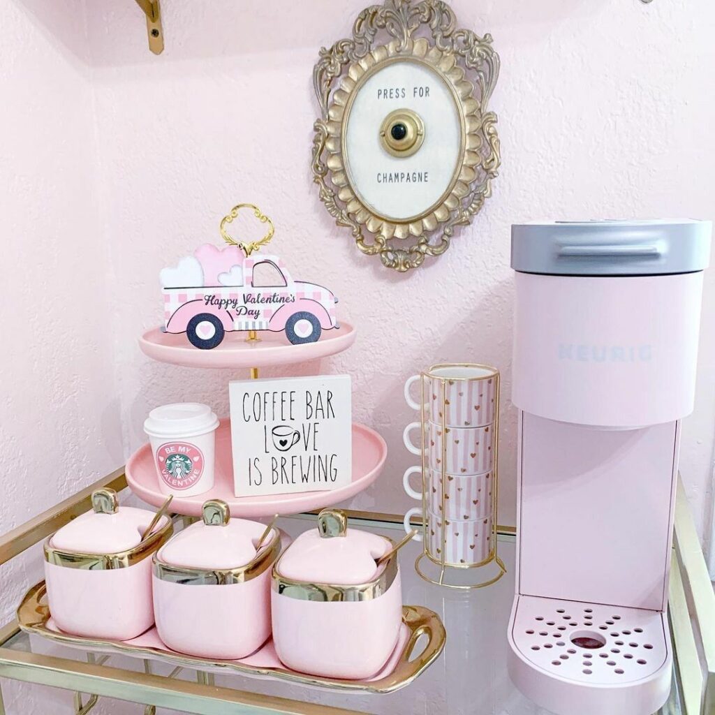 Pink and gold sugar jars with spoons on a glass and gold coffee cart