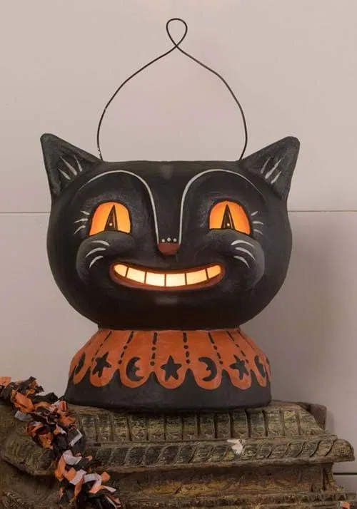 Vintage Halloween decor paper mache black cat with glowing cutout eyes and a moon-and-star collar