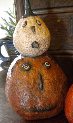 Primitive paper mache jack-o-lantern with a hand-painted face, styled as vintage Halloween decor