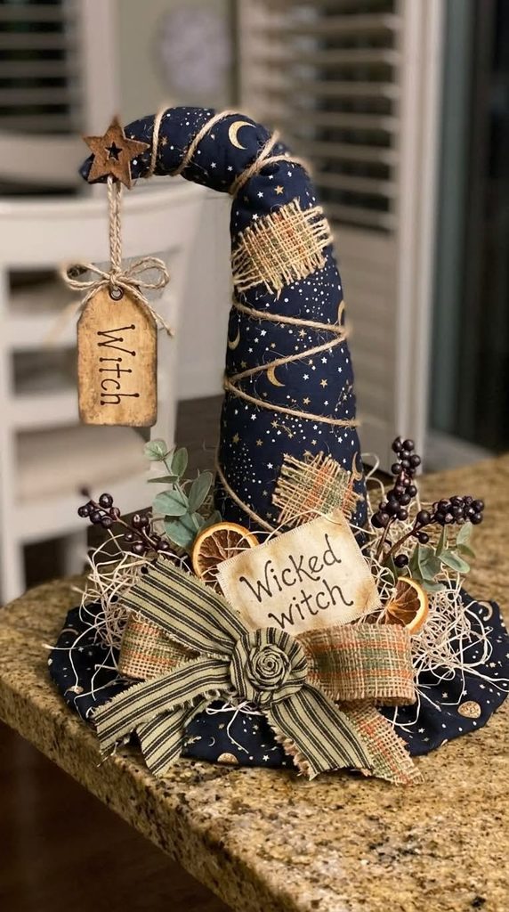 Weathered primitive witch hat with a "Wicked Witch" tag, styled as vintage Halloween decor