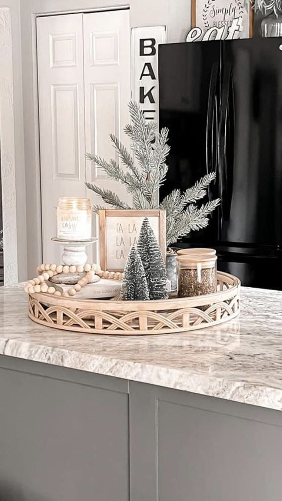 Christmas coffee table tray with white ceramic trees and pinecones on a wood coffee table in a living room