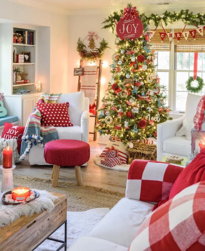 White sofa in a Christmas living room with red checked pillows and a plaid throw