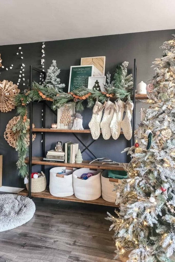 Christmas stockings hung along a living room shelf as part of Christmas living room decor ideas