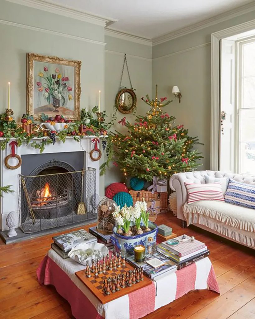 Vintage Christmas living room with a fruit and ivy mantel and a tree decorated with dried orange slices and red bows